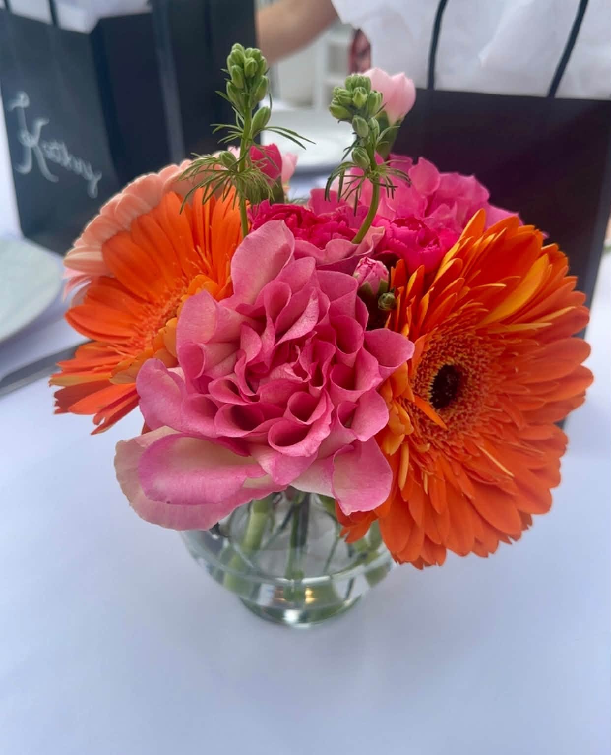 Pink and orange flowers in a glass vase