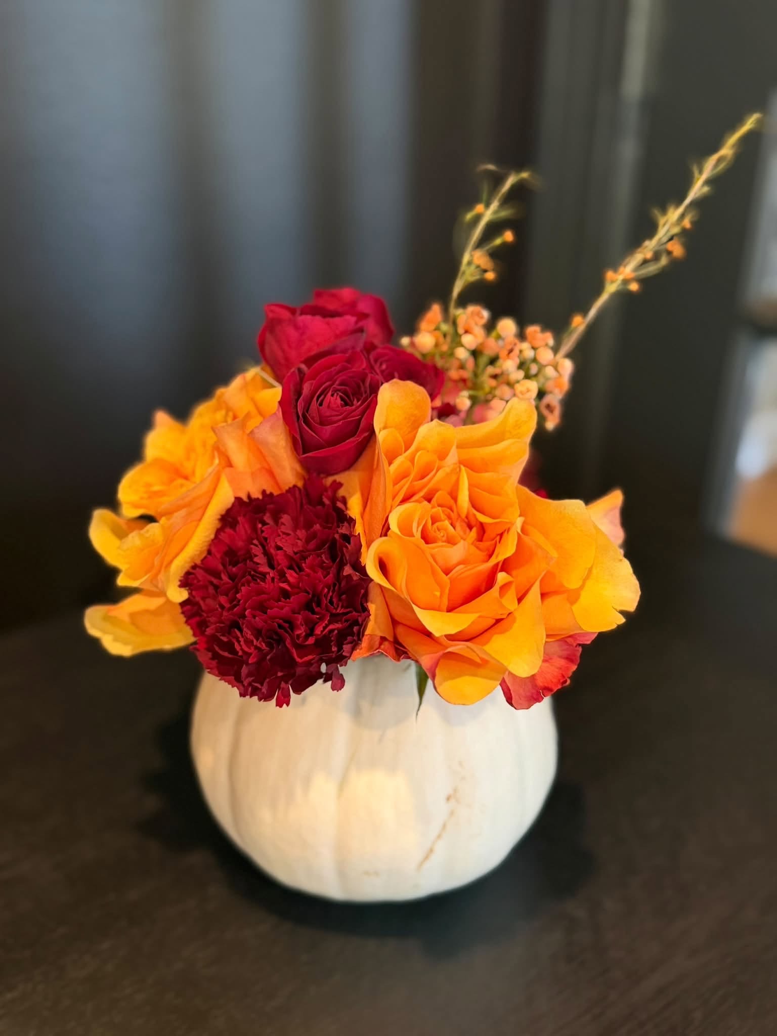 Autumn flowers in a white pumpkin