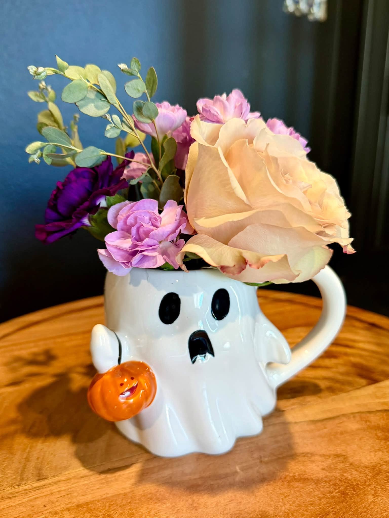 Pale pink flowers in a ghost mug